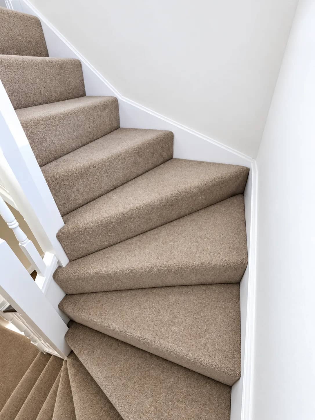 Carpet cleaned across winder stairs where wear shows first.